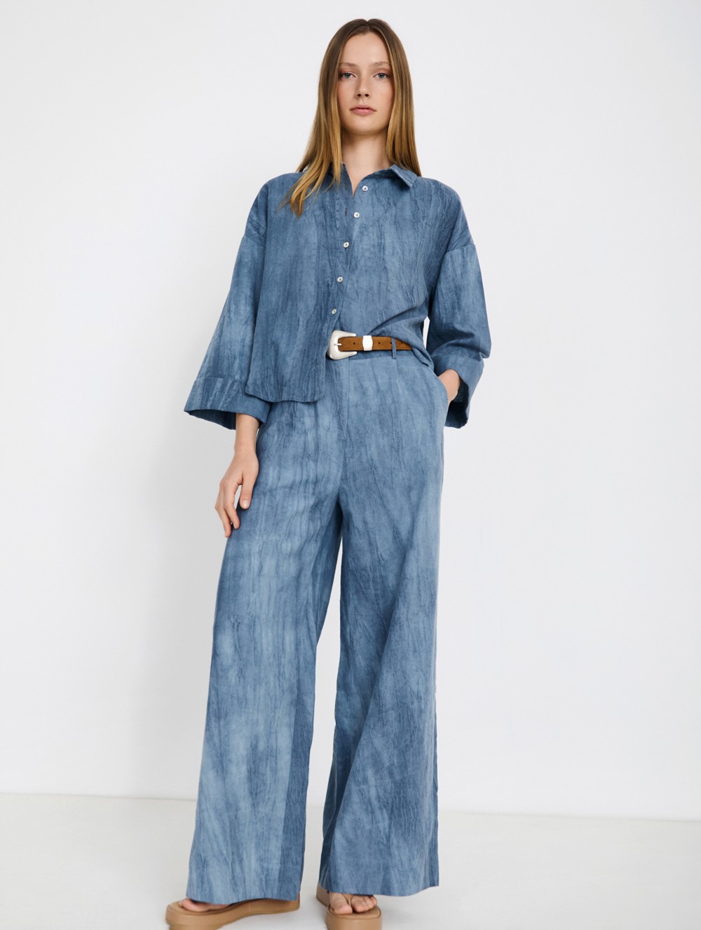 Distressed trousers with pleats