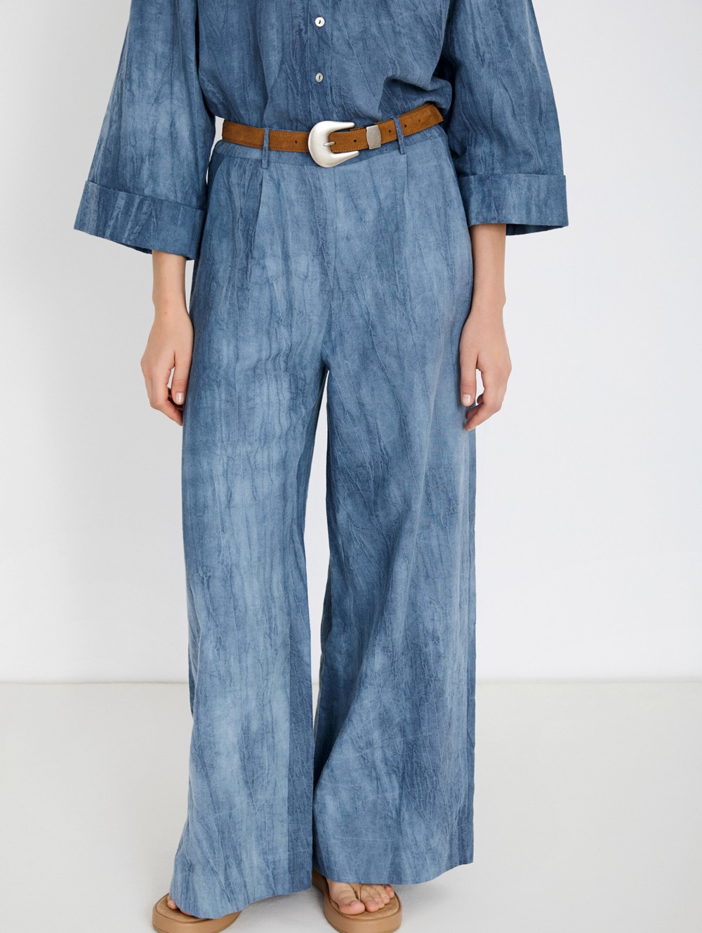 Distressed trousers with pleats
