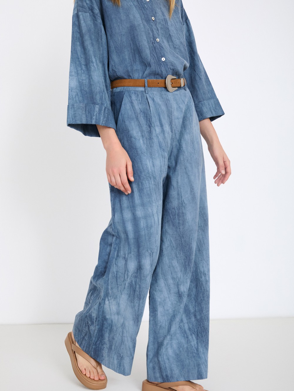 Distressed trousers with pleats