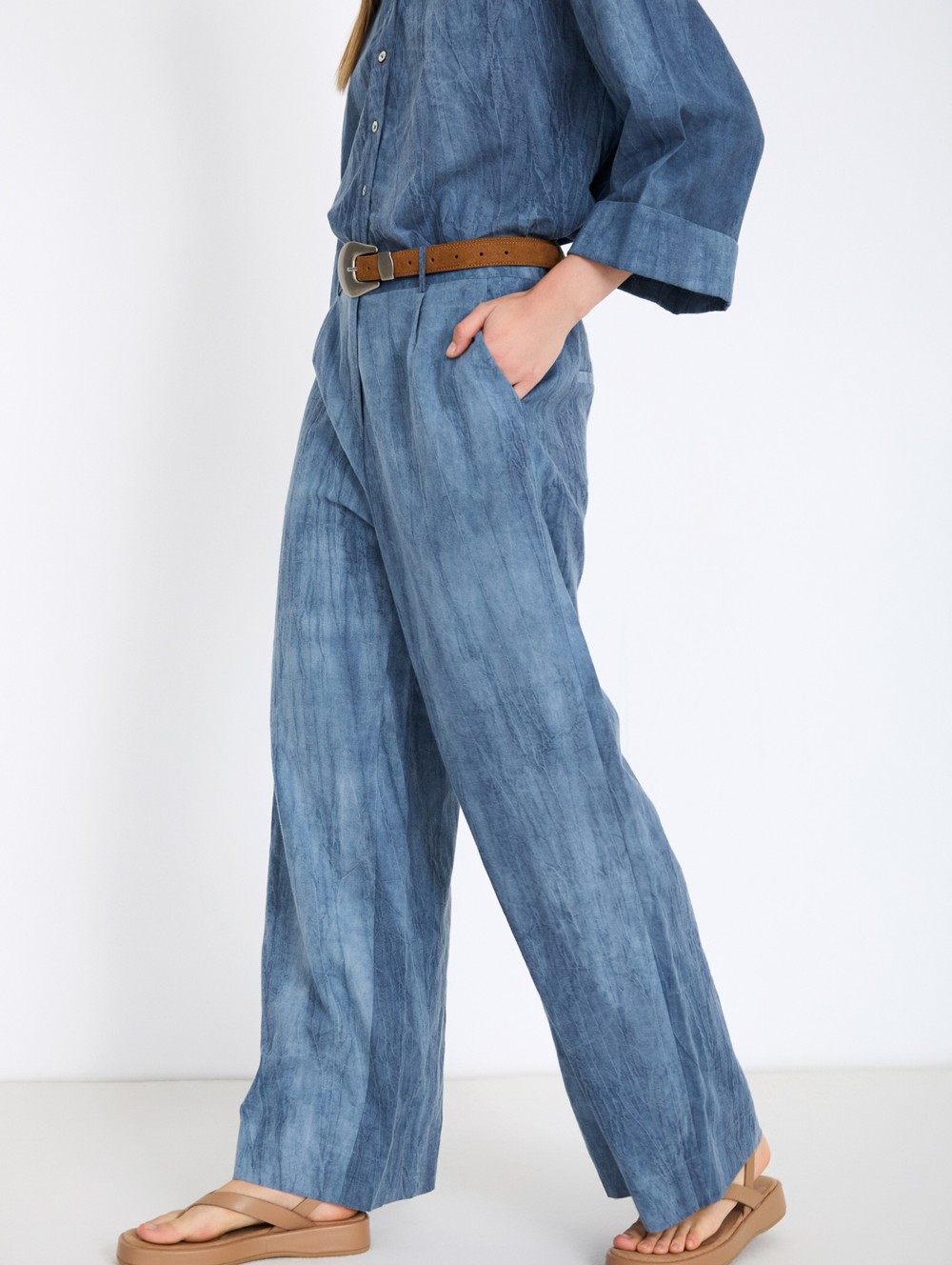 Distressed trousers with pleats