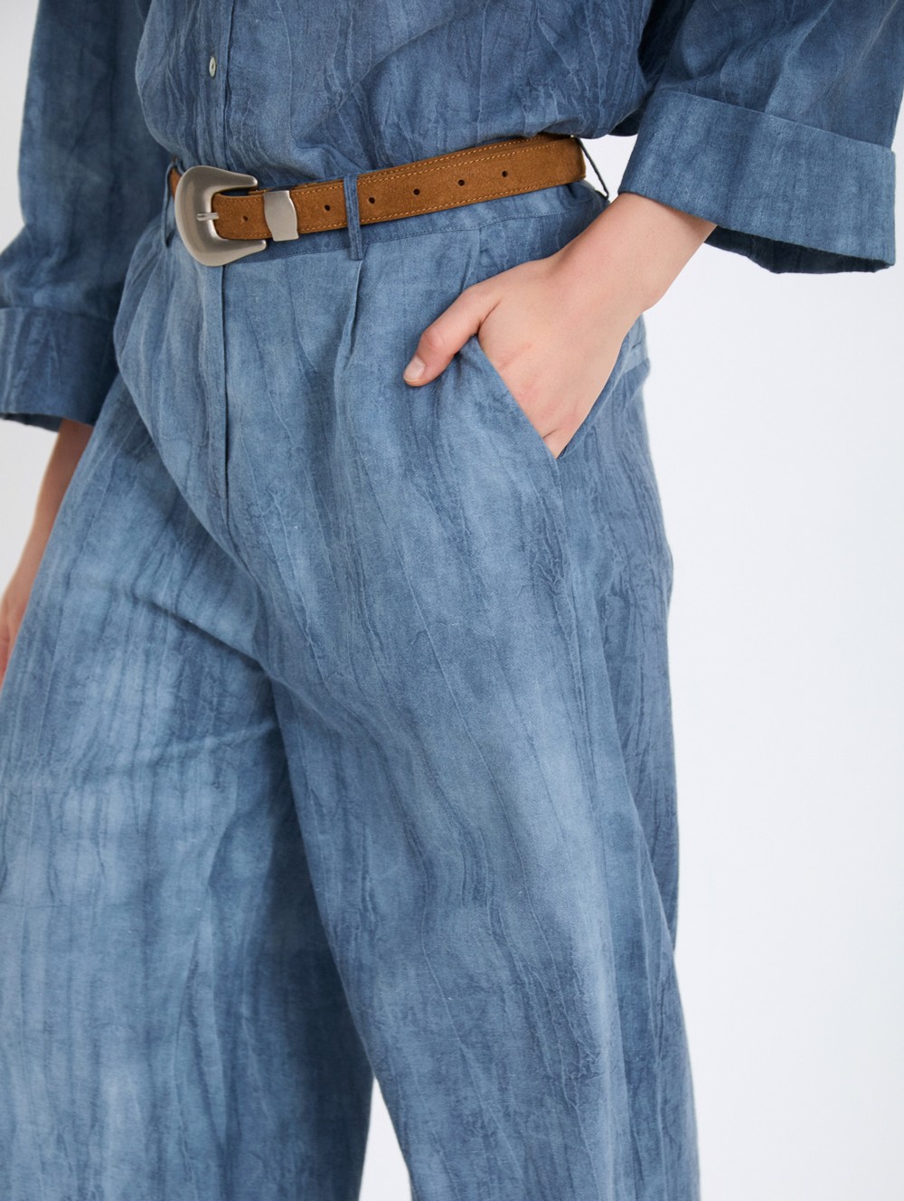 Distressed trousers with pleats