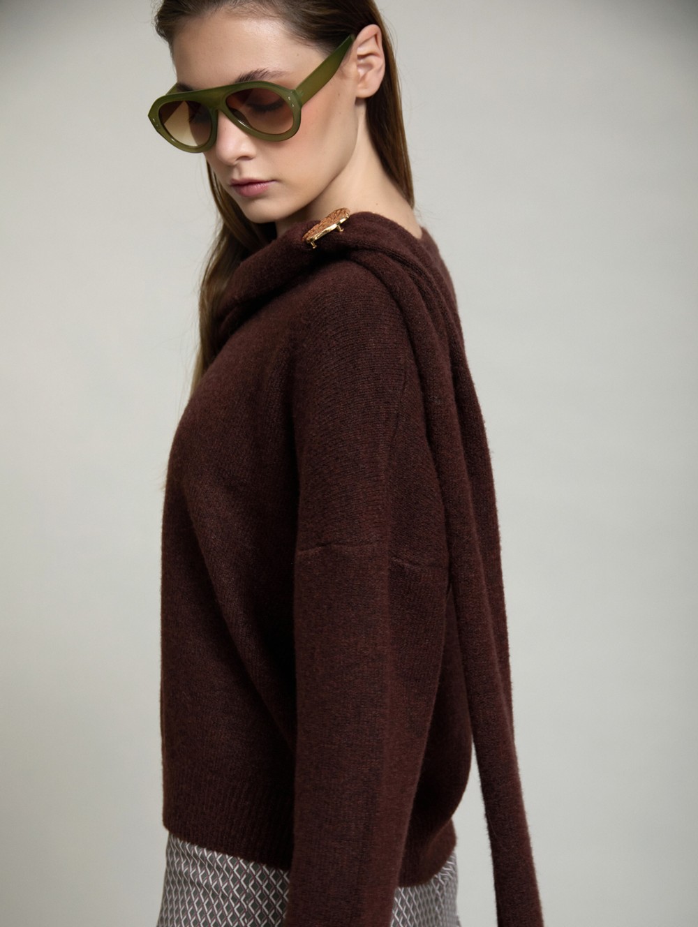 Sweater with gold brooch scarf